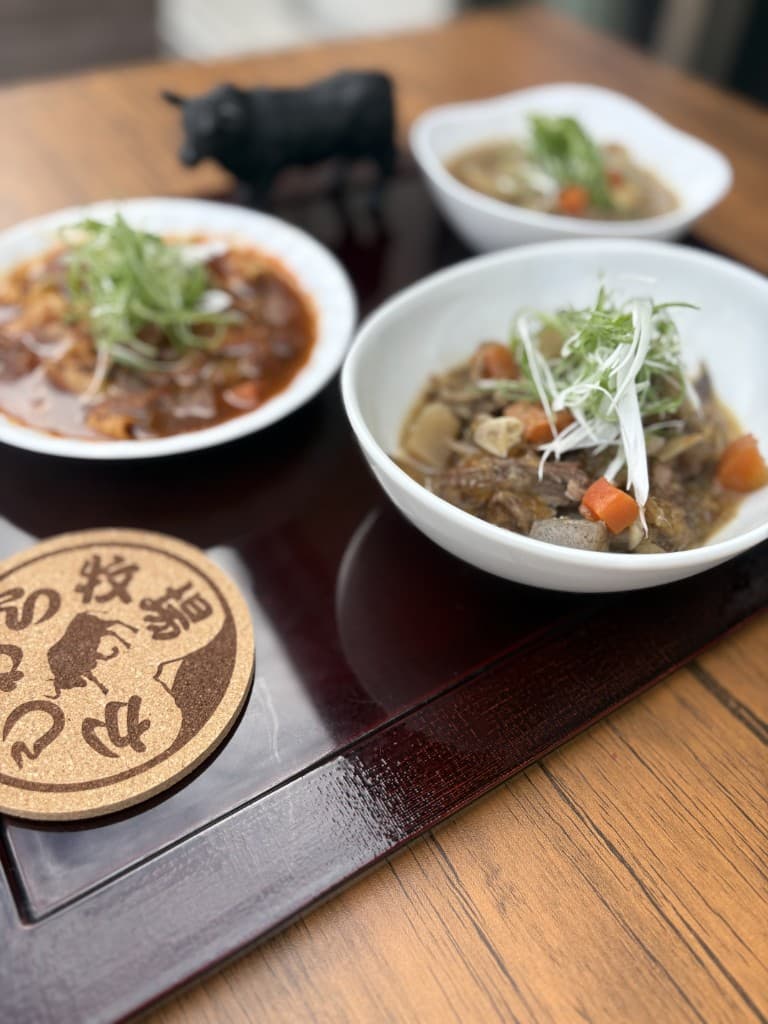 梶原牧場の牛肉を使った煮込み料理と牛の置物・ロゴ入りコースター
